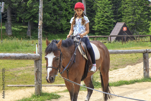 Young girl riding a horse © Vladislav Gajic