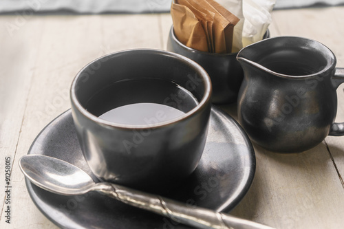 Coffee cup and milk cup with sugar and cream pack