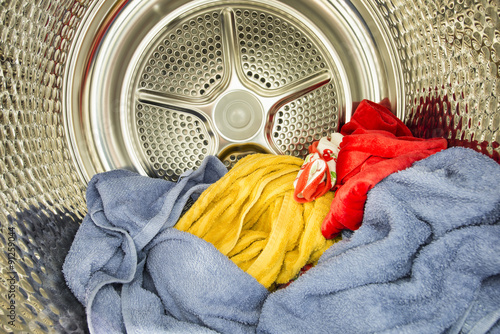 Inside of tumble dryer with drying laundry photo