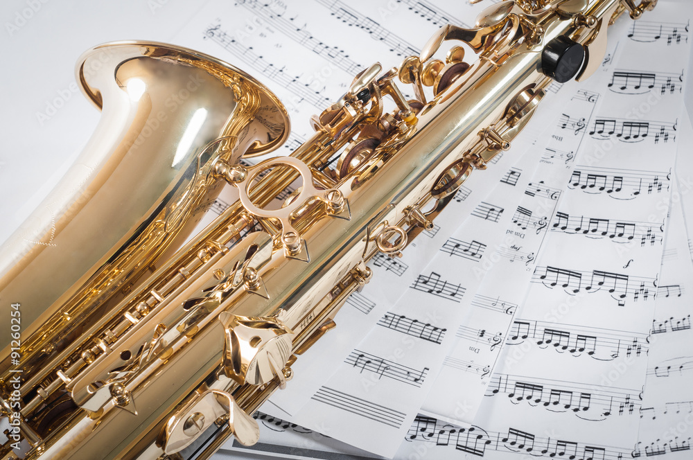 Obraz premium Part of saxophone lying on the notes