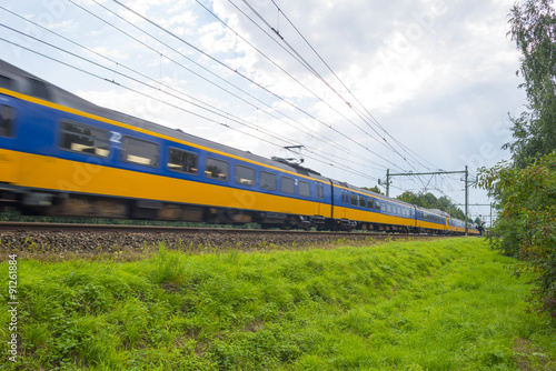 Passenger train driving at high speed in summer 