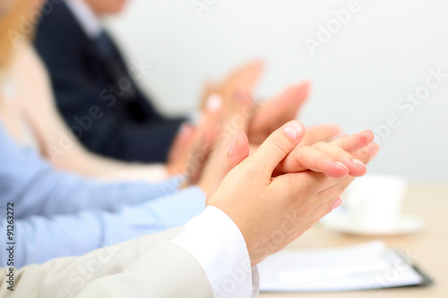 Close-up of business people clapping hands. Business seminar con