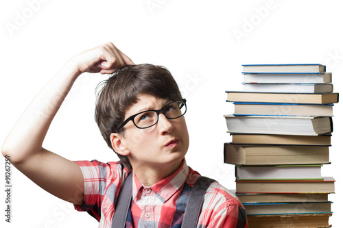 Pensive girl near  a stack of books