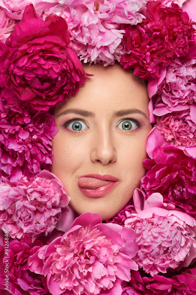 Woman face in peony flowers