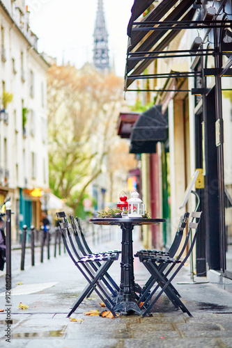 Tables of a Parisian cafe decorated for Christmas #91268672