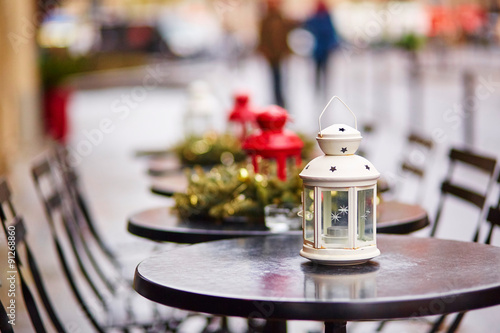 Tables of a Parisian cafe decorated for Christmas