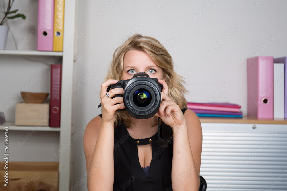 Photographer woman girl is holding a camera taking photographs Photographer woman girl is holding a camera taking photographs