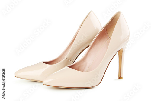 Canvas-taulu Pair of beige women's high-heeled shoes isolated on a white