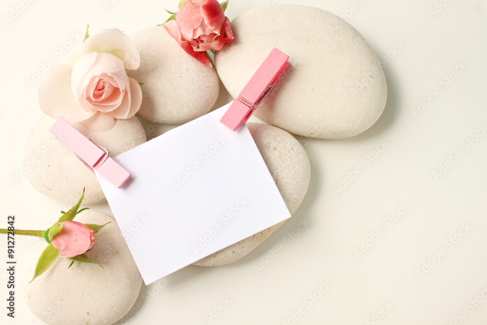 Empty note paper pink pins and delicate roses,white spa stones, feminine creamy tones decoration, blank space, soft focus Empty note paper pink pins and delicate roses,white spa stones, feminine creamy tones decoration, blank space, soft focus