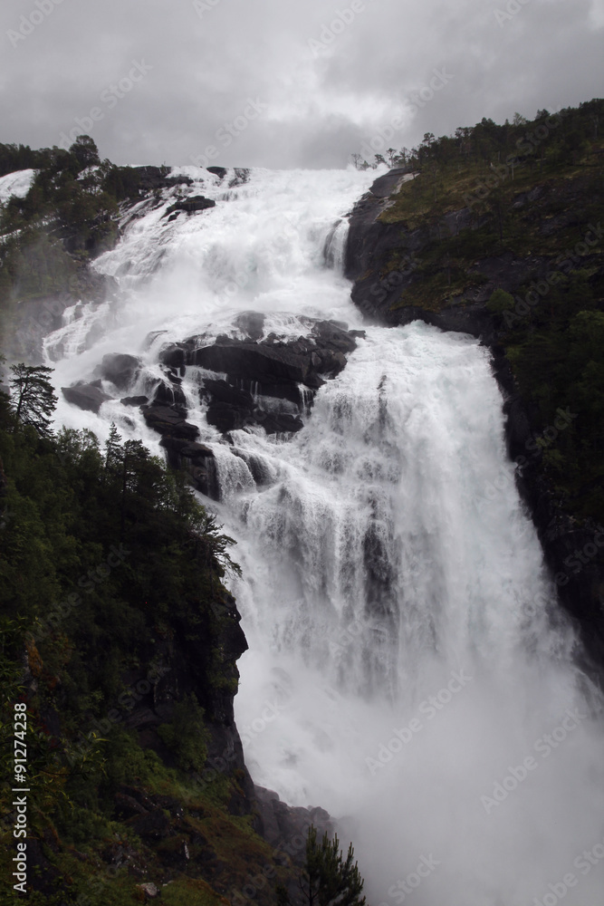 Waterfall in Husedalen valley in Hardangervidda national park, Norway Waterfall in Husedalen valley in Hardangervidda national park, Norway