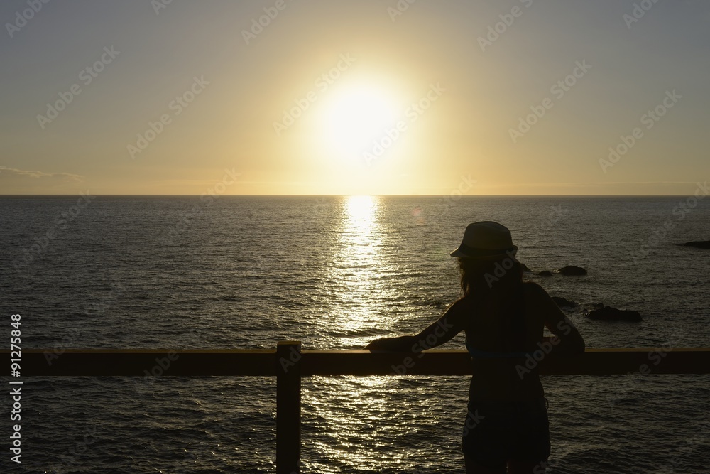 Woman silhouette and sun