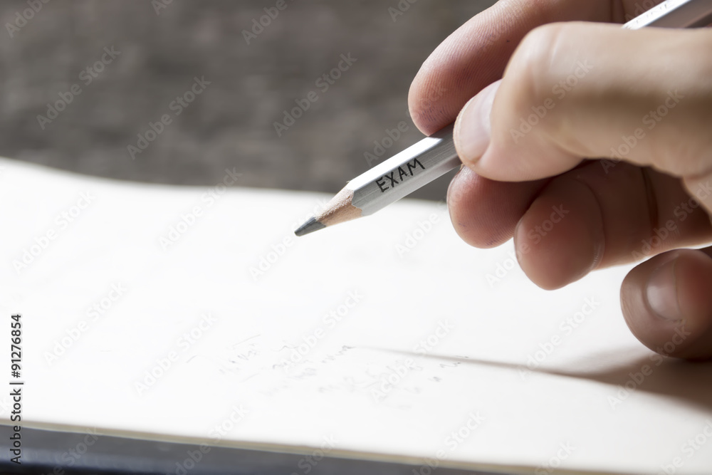Student writing a test, an inscription on pencil Student writing a test, an inscription on pencil