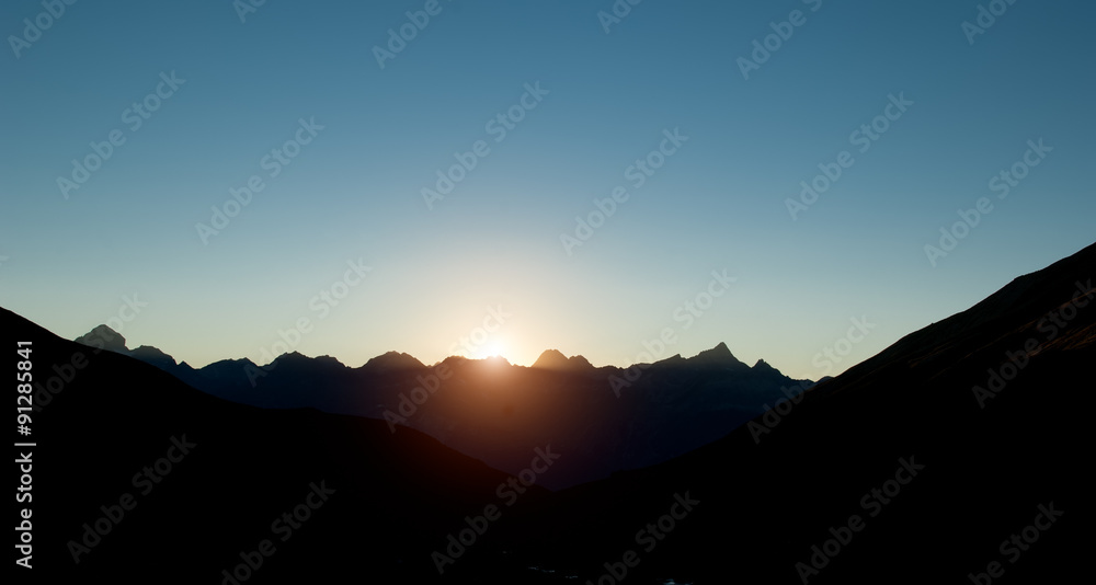 sunset on the dark mountain in silhouette