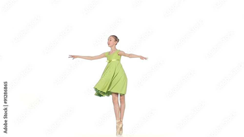 Ballerina in green dress posing on a white. slow motion Ballerina in green dress posing on a white. slow motion