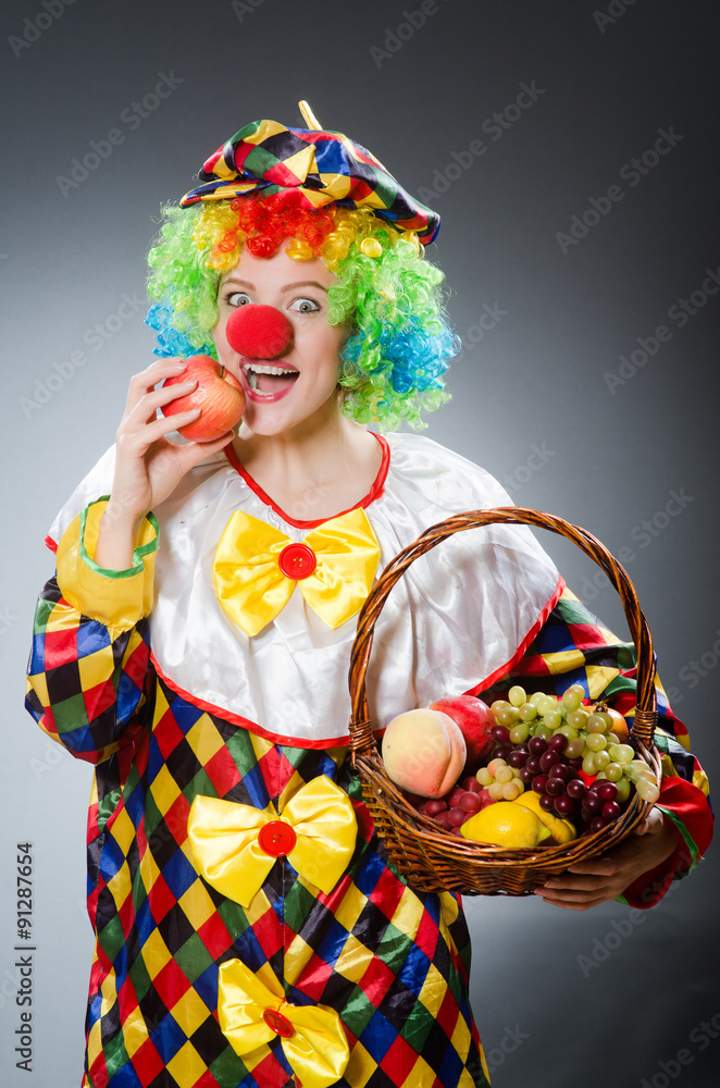 Clown with fruits in funny concept