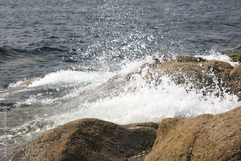 waves crashing against a rocky shore