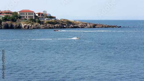 Tourists are sailing with boats in the Black sea's waters at the central beach of Sozopol. photo