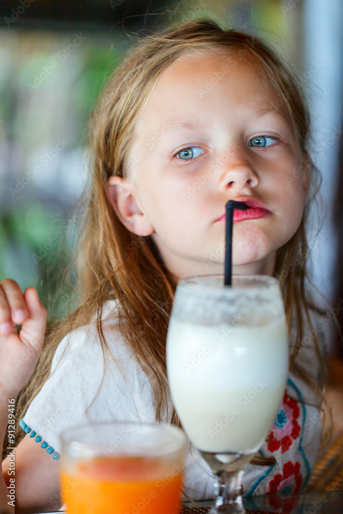 Little girl drinking smoothie outdoors Little girl drinking smoothie outdoors