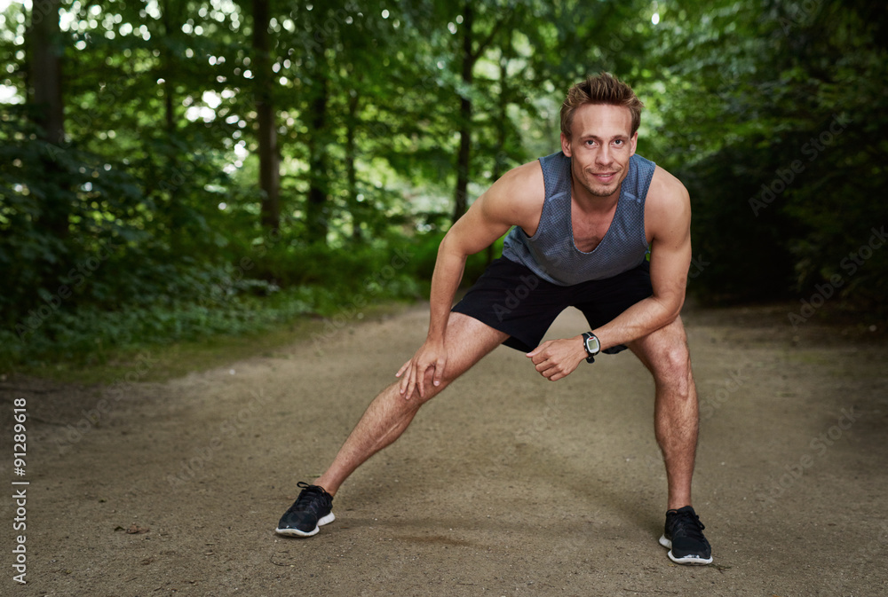Athletic Man Doing Warm Up Exercise at the Park Athletic Man Doing Warm Up Exercise at the Park