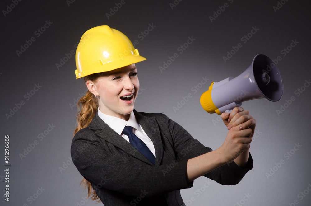 Construction worker in helmet against gray Construction worker in helmet against gray