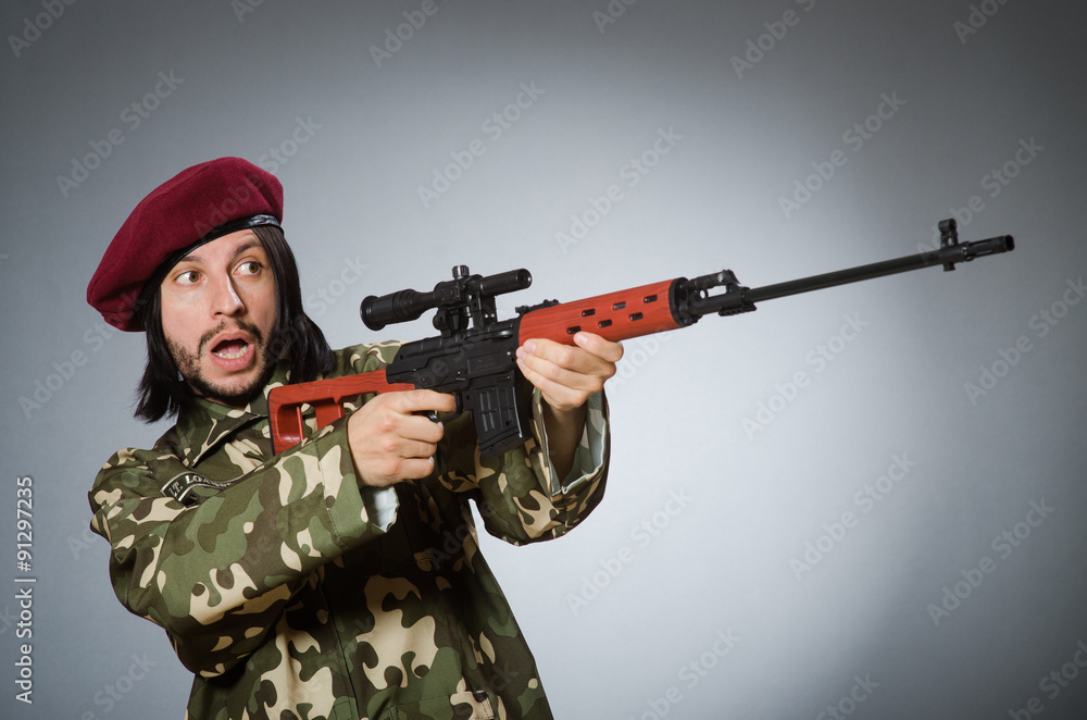 Soldier with handgun against gray Soldier with handgun against gray