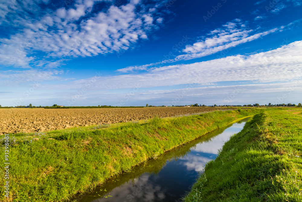 Naklejka premium irrigation canal in Italian countryside