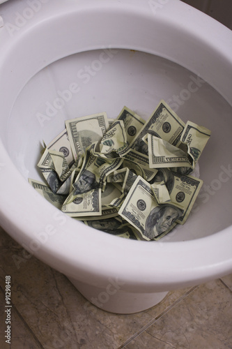 Fotografie dirty toilet with money close up, lot of cash useless