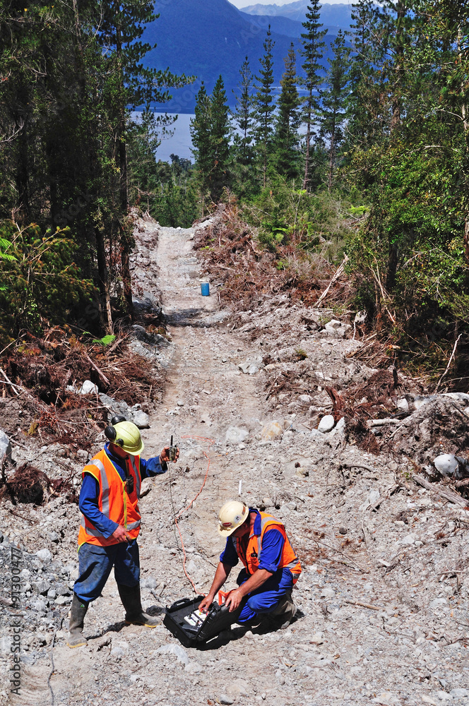 Obraz premium men set off charges for a seismic reflective survey on a oil field