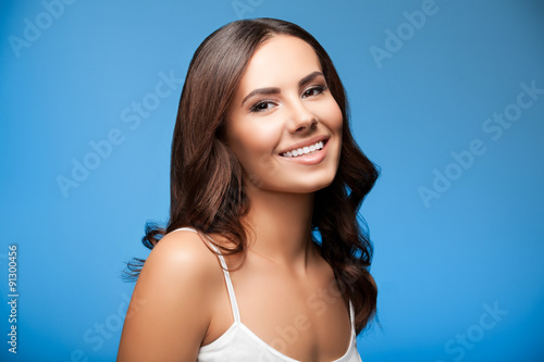 smiling young woman, on blue