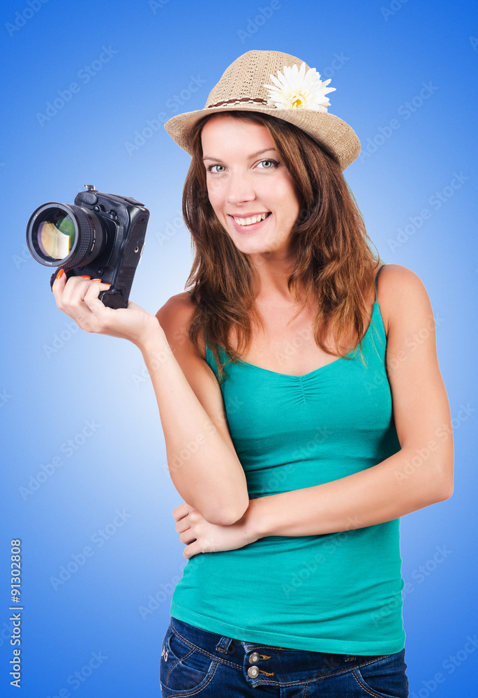 Fototapeta premium Attractive female photographer on white
