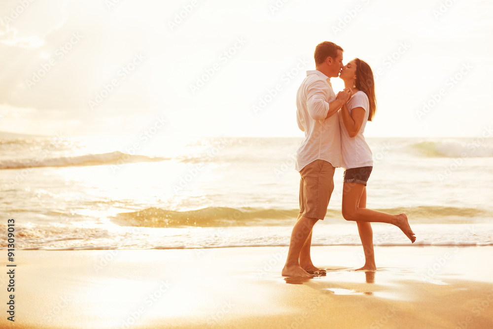 Romantic Couple Kissing on the Beach at Sunset
