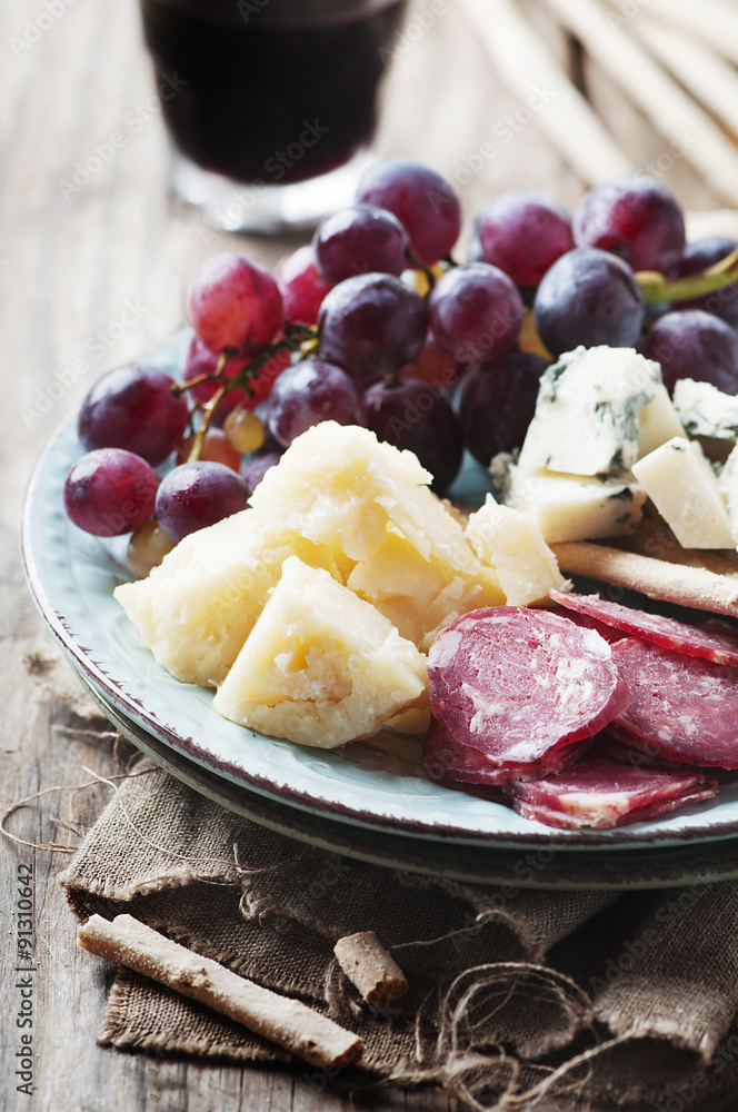 Antipasto with cheese, sausage and grape Antipasto with cheese, sausage and grape