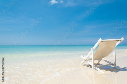 Fototapeta Naklejka Na Ścianę i Meble -  beach chair on beach with blue sky