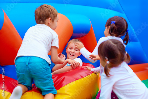 excited kids having fun on inflatable attraction playground