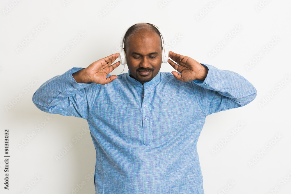 indian male enjoying music in traditional wear indian male enjoying music in traditional wear