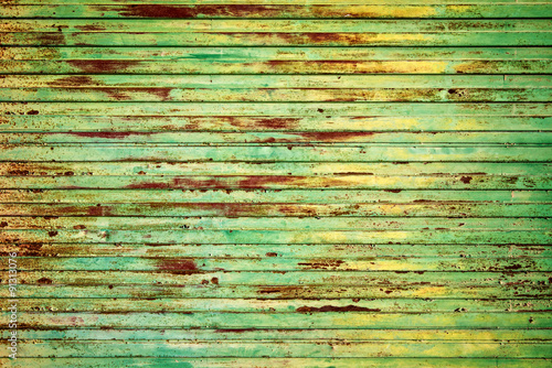 Green rusty metal background with peeling paint