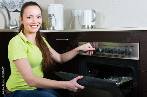 Woman cooking meal in the oven