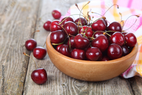 Ripe cherry in a wooden bowl