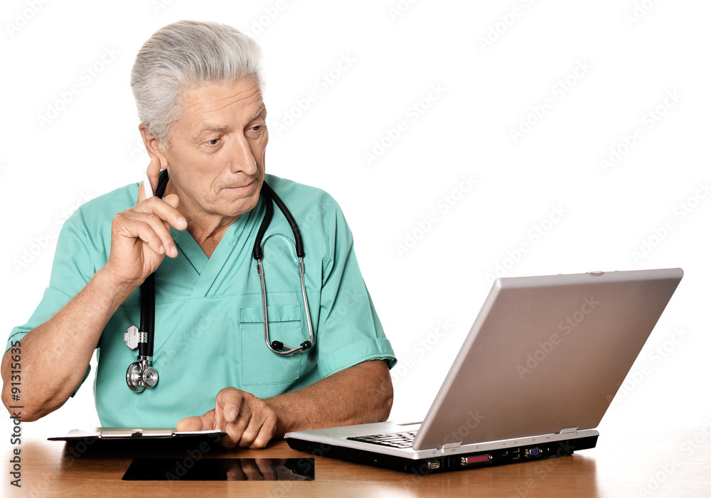 Elderly doctor with laptop Elderly doctor with laptop