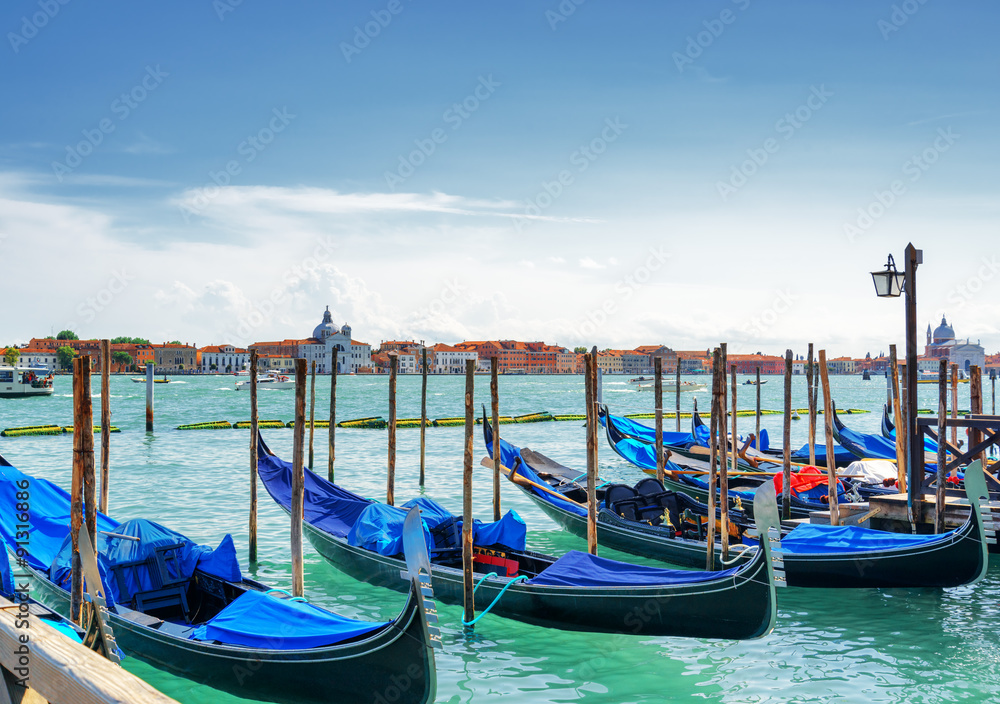 Gondolas parked beside the Riva degli Schiavoni in Venice, Italy