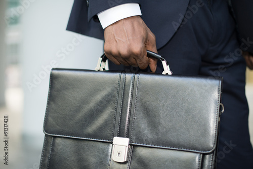 Businessman holding his briefcase photo