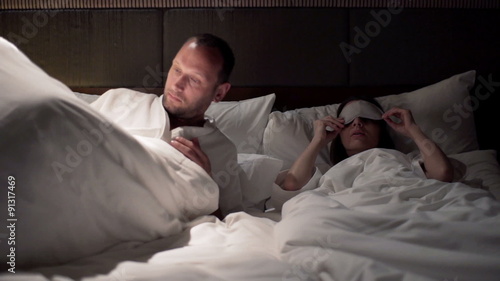 Young couple kissing for goodnight and going to sleep
