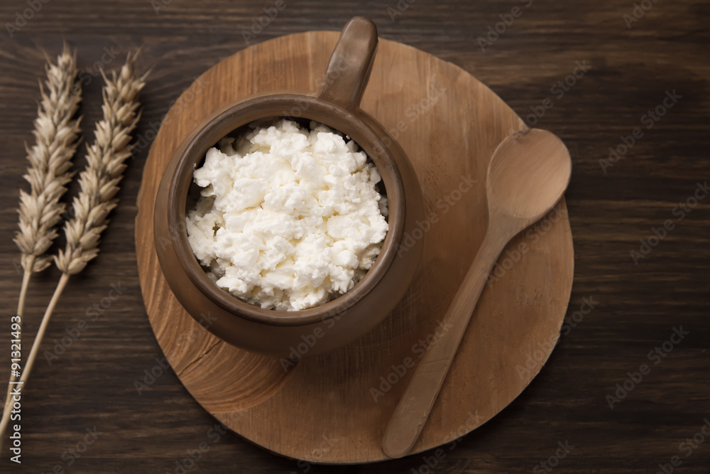 fresh tasty curd in pot on wooden background. Homemade, cottage cheese fresh tasty curd in pot on wooden background. Homemade, cottage cheese
