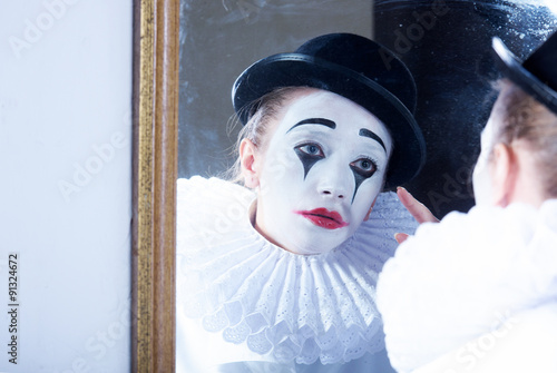 Fényképezés Sad mime Pierrot looking at the mirror