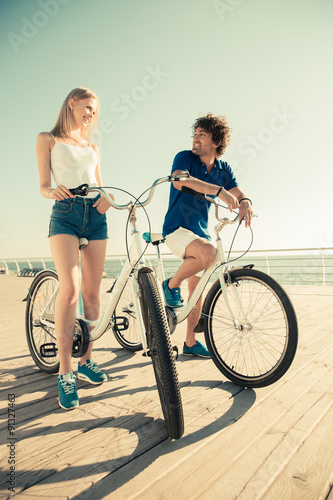 Fototapeta Naklejka Na Ścianę i Meble -  Man and woman riding on bicycle outdoors