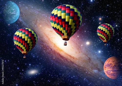 Hot air balloon surreal wonderland fairy tale landscape fantasy planets. Elements of this image furnished by NASA.