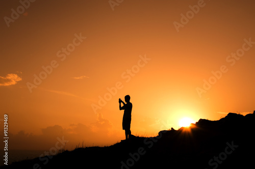 silhouette people taking picture with mobile phone on the hills