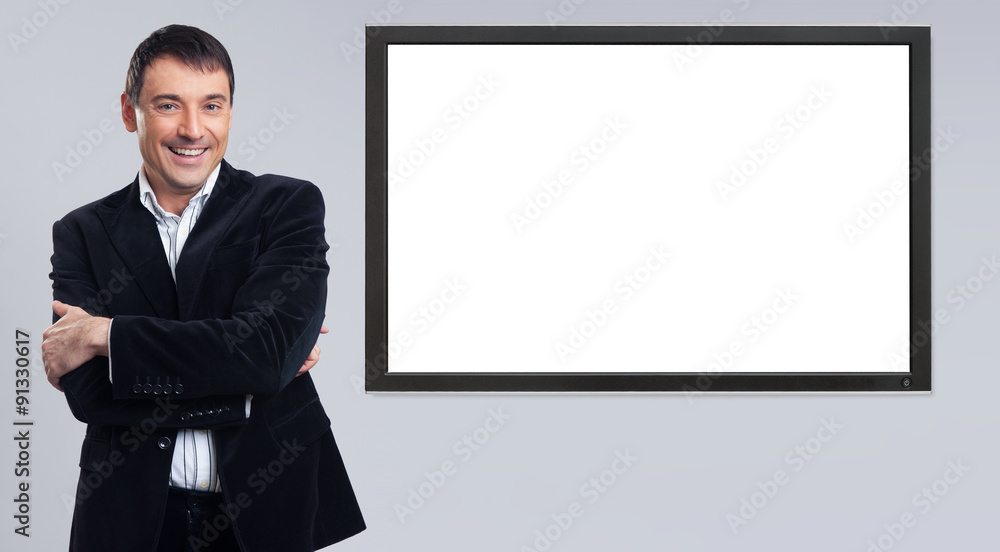 Cheerful young businessman showing blank pc monitor Cheerful young businessman showing blank pc monitor