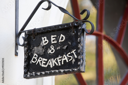 Metal Bed and Breakfast sign on building 