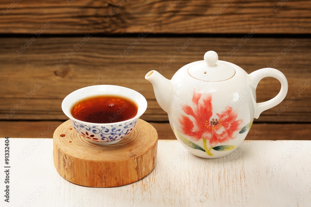 Puerh tea in white bowl brewed in white porcelain pot Puerh tea in white bowl brewed in white porcelain pot